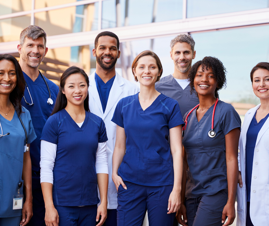 eight doctors standing outside together smiling