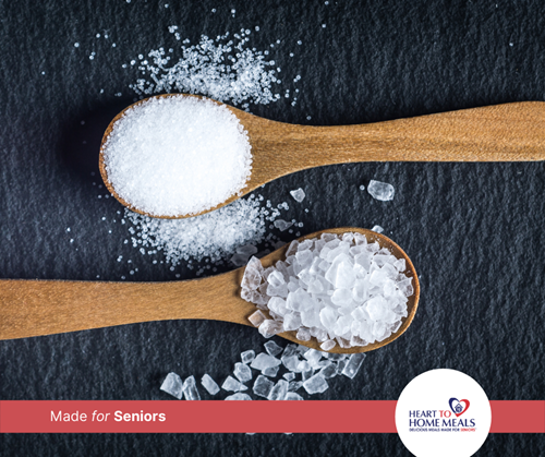 two wooden spoons with salt