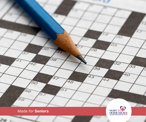 Pencil left sitting on an unfinished crossword puzzle
